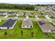 Aerial view showing the homes and green landscaping in the neighborhood at 756 Rioja Dr, Minneola, FL 34715