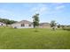 Expansive backyard featuring a lush lawn and young trees, ideal for outdoor activities at 756 Rioja Dr, Minneola, FL 34715