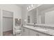 Bright bathroom boasts double vanity with granite countertop and a spacious walk-in closet at 756 Rioja Dr, Minneola, FL 34715