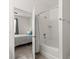 Bathroom featuring a shower-tub combo, with a view into the connected bedroom at 756 Rioja Dr, Minneola, FL 34715