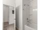 Bathroom featuring a shower-tub combo with a view into the hallway at 756 Rioja Dr, Minneola, FL 34715