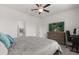 Cozy bedroom with ceiling fan, carpet, and adjacent bathroom with a wooden dresser and desk space at 756 Rioja Dr, Minneola, FL 34715
