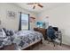 Bedroom with a ceiling fan, window, and a desk area at 756 Rioja Dr, Minneola, FL 34715