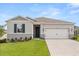 Charming single-story home with well-manicured lawn and attached two-car garage at 756 Rioja Dr, Minneola, FL 34715