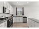 Well-equipped kitchen with granite countertops and stainless steel appliances, including an oven and dishwasher at 756 Rioja Dr, Minneola, FL 34715