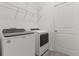 Laundry room equipped with washer, dryer, and wire shelving for storage at 756 Rioja Dr, Minneola, FL 34715