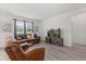 Bright living room offering wood floors, a large window, comfortable seating, and a modern entertainment center at 756 Rioja Dr, Minneola, FL 34715