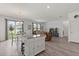 Spacious open-concept living area featuring wood floors, a dining area, and a modern kitchen at 756 Rioja Dr, Minneola, FL 34715