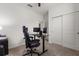 Office area with a ceiling fan, sliding closet doors, and an office desk at 756 Rioja Dr, Minneola, FL 34715