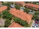 Aerial view of tile roofed residences with ample parking and landscaping at 7625 Long Island Dr, Kissimmee, FL 34747
