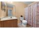 Well-maintained bathroom featuring large mirror, vanity, and shower with curtain at 7625 Long Island Dr, Kissimmee, FL 34747