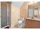 Functional bathroom with a glass-enclosed shower, standard toilet, and a vanity with sink at 7625 Long Island Dr, Kissimmee, FL 34747