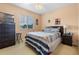 Comfortable bedroom featuring natural light and a striped comforter set at 7625 Long Island Dr, Kissimmee, FL 34747