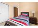 Serene bedroom with a comfortable bed and a side table with a lamp at 7625 Long Island Dr, Kissimmee, FL 34747