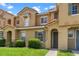 Inviting townhome showcasing a well-maintained lawn and beautiful terra cotta roof at 7625 Long Island Dr, Kissimmee, FL 34747