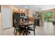 Eat-in kitchen featuring wood cabinets, tile flooring, and slider doors to the backyard at 7625 Long Island Dr, Kissimmee, FL 34747