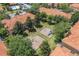Aerial shot of a playground nestled between buildings and lush trees featuring swings and a slide at 7625 Long Island Dr, Kissimmee, FL 34747
