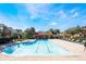 Community pool surrounded by lounge chairs and well-maintained landscaping at 7625 Long Island Dr, Kissimmee, FL 34747