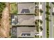 Overhead view of homes with solar panels and screened pools, situated on a well-planned street at 7778 Four Seasons Blvd, Kissimmee, FL 34747