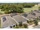 Aerial view of homes featuring solar panels and screened-in pools in a lush community setting at 7778 Four Seasons Blvd, Kissimmee, FL 34747
