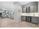 Stylish bar area featuring sleek cabinetry, wine refrigerator, and easy access to the living room at 7778 Four Seasons Blvd, Kissimmee, FL 34747