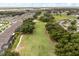 An aerial view shows a well-maintained golf course winding through a residential neighborhood at 7778 Four Seasons Blvd, Kissimmee, FL 34747
