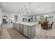 Open-concept kitchen featuring a spacious island, modern appliances, and seamless flow into the living area at 7778 Four Seasons Blvd, Kissimmee, FL 34747