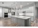 Bright kitchen features an oversized island, modern appliances, pendant lighting, and hardwood floors at 7778 Four Seasons Blvd, Kissimmee, FL 34747