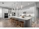 Bright kitchen features an oversized island, modern appliances, pendant lighting, and hardwood floors at 7778 Four Seasons Blvd, Kissimmee, FL 34747