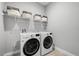 Bright laundry room featuring a front loading washer and dryer at 7778 Four Seasons Blvd, Kissimmee, FL 34747