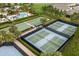 Overhead view of a community pickleball area with multiple courts, bocce ball, and a nearby pool at 7778 Four Seasons Blvd, Kissimmee, FL 34747