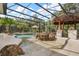 Enclosed pool with palm trees, tiki bar, fire pit, and tanning ledge at 7778 Four Seasons Blvd, Kissimmee, FL 34747