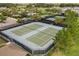Aerial view of a community tennis court featuring well-maintained green courts, and black fencing at 7778 Four Seasons Blvd, Kissimmee, FL 34747