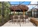 Covered tiki bar boasts seating for six, a built-in grill, and picturesque views of the pool at 7778 Four Seasons Blvd, Kissimmee, FL 34747