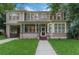 Charming two-story home featuring a screened front porch, classic architectural details, and lush green lawn at 803 E Hardwood St, Orlando, FL 32803