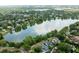 Scenic aerial view of a lakefront neighborhood showcasing a picturesque lake and beautiful surrounding homes at 820 Ellwood Ave # A, Orlando, FL 32804