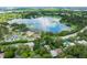 Charming aerial view capturing a serene lake, lush greenery, and beautiful homes in a peaceful community at 820 Ellwood Ave # A, Orlando, FL 32804