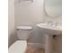 Elegant powder room with a pedestal sink, round mirror, and tiled floor at 820 Ellwood Ave # A, Orlando, FL 32804