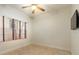 Bright bedroom featuring neutral walls, tile flooring, and a large window with wood blinds at 820 Ellwood Ave # A, Orlando, FL 32804