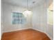 Dining room featuring hardwood floors, natural light, and a stylish chandelier at 820 Ellwood Ave # A, Orlando, FL 32804