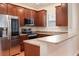 Kitchen with wood cabinets, stainless steel appliances, and granite countertops at 820 Ellwood Ave # A, Orlando, FL 32804