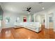 Bright living room featuring hardwood floors, large windows, and a ceiling fan at 820 Ellwood Ave # A, Orlando, FL 32804