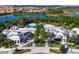 Aerial view of the clubhouse amenities, pool and splash pad with lake views at 832 Longboat Dr, Davenport, FL 33896