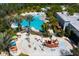 Aerial view of community pool and splash area with many amenities and lush landscaping at 832 Longboat Dr, Davenport, FL 33896