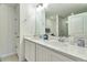 Clean, bright bathroom featuring double vanity, neutral granite countertops, and chrome fixtures at 832 Longboat Dr, Davenport, FL 33896