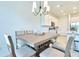 Bright dining area adjacent to the kitchen, featuring a modern chandelier and stylish furnishings at 832 Longboat Dr, Davenport, FL 33896
