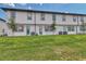 Exterior view of townhome from the back yard with sod and young trees at 832 Longboat Dr, Davenport, FL 33896