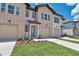 Charming two-story townhouse with a well-maintained lawn and inviting blue front door at 832 Longboat Dr, Davenport, FL 33896