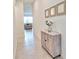 Inviting hallway featuring a decorative cabinet with flowers and views into the living area at 832 Longboat Dr, Davenport, FL 33896