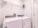 Bright laundry room features a Whirlpool washer and dryer and a shelf for added storage at 832 Longboat Dr, Davenport, FL 33896